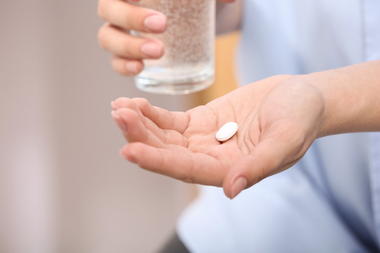 Adult Taking a Multivitamin