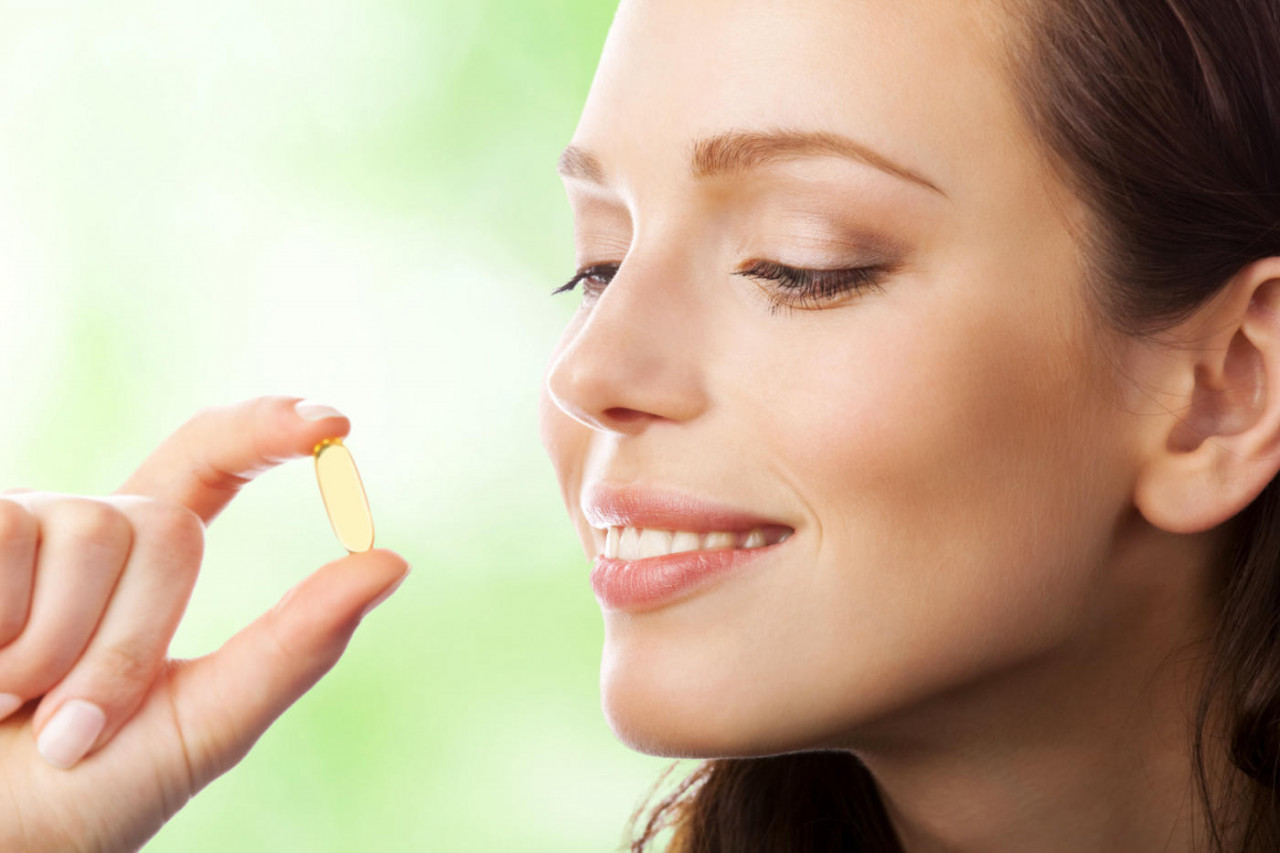Female Consumer Looking at Omega-3 Supplement